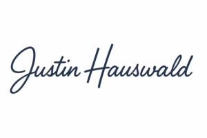 Unterschrift von Justin Hauswald in blauem Handschrift-Stil